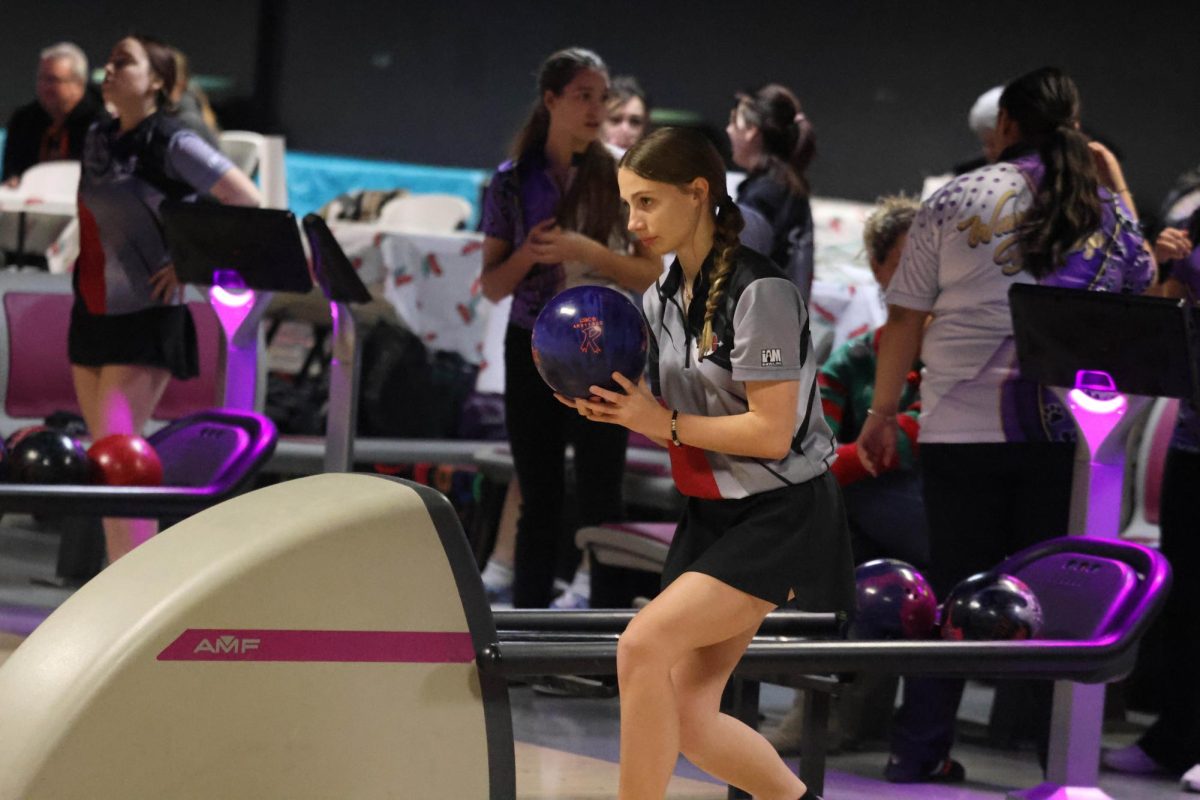 Sophomore Jocelyn Knuth preparing for a approach during the match vs Wauconda.