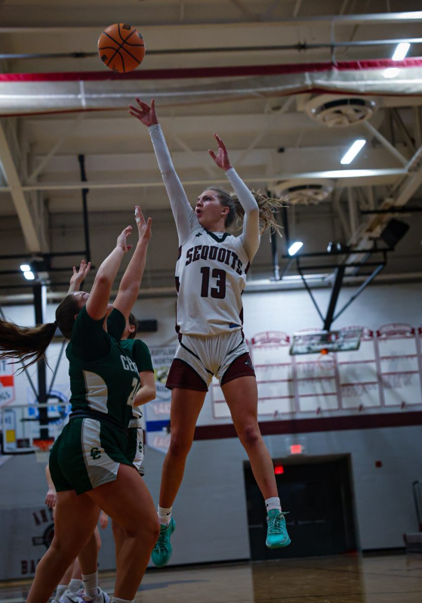 Junior Heidi Rathmann shooting a mid range shot over two defenders